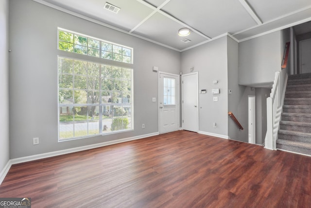 entrance foyer featuring dark hardwood / wood-style floors and a towering ceiling