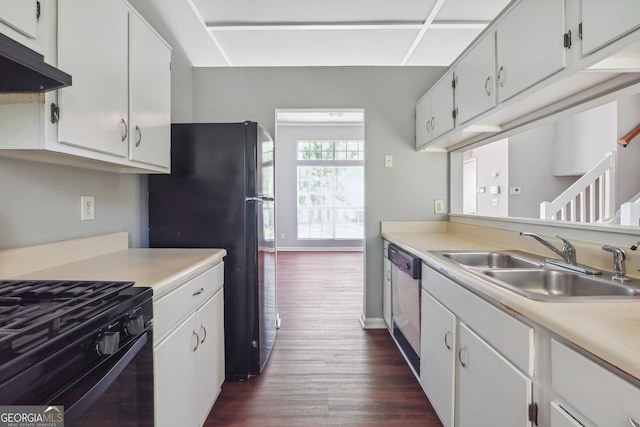 kitchen featuring white cabinetry, black appliances, dark hardwood / wood-style flooring, and sink