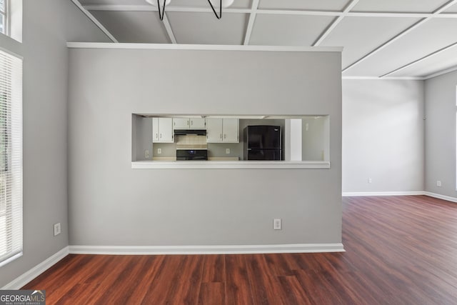 unfurnished living room featuring dark hardwood / wood-style floors