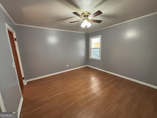 unfurnished room featuring ceiling fan, dark hardwood / wood-style floors, and ornamental molding