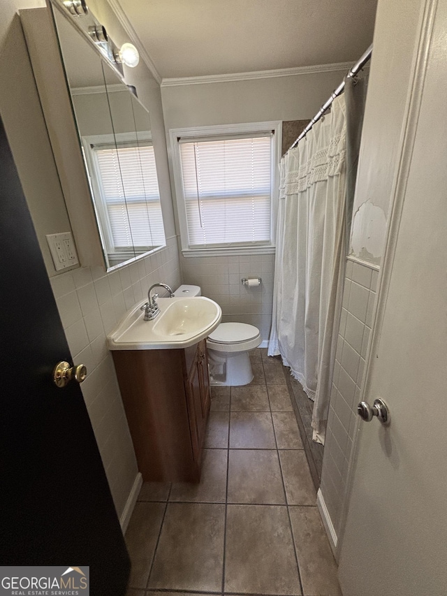 bathroom with tile patterned flooring, vanity, tile walls, toilet, and crown molding