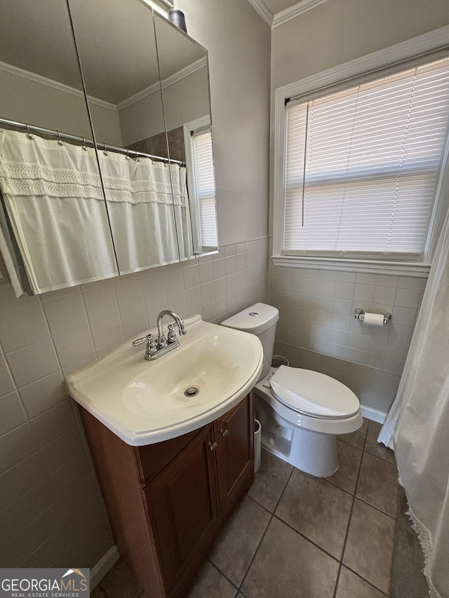 bathroom with tile patterned flooring, vanity, tile walls, and toilet