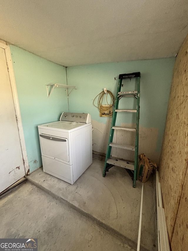 washroom featuring a textured ceiling and washer / clothes dryer