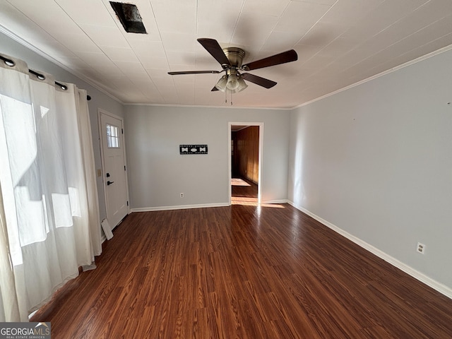 empty room with ceiling fan, dark hardwood / wood-style flooring, and ornamental molding