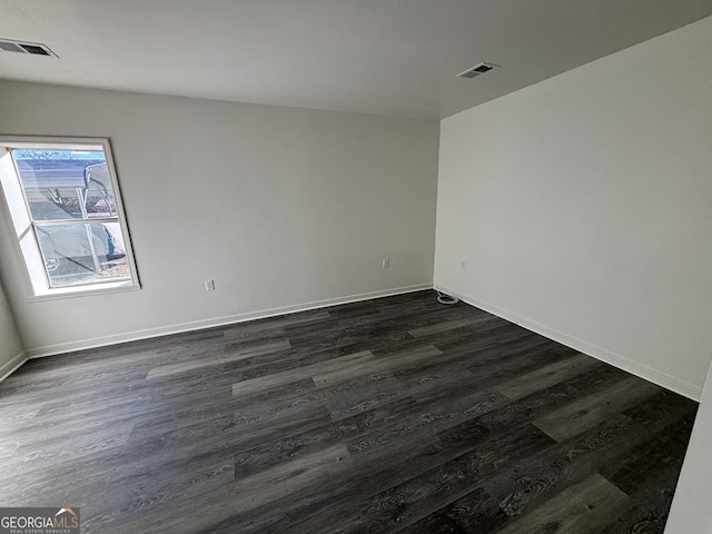 unfurnished room featuring dark hardwood / wood-style flooring