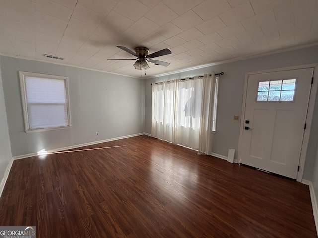 entrance foyer featuring ceiling fan, dark hardwood / wood-style flooring, and ornamental molding