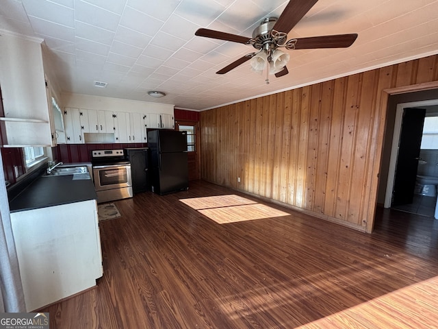 kitchen with white cabinets, black refrigerator, dark hardwood / wood-style flooring, sink, and electric range