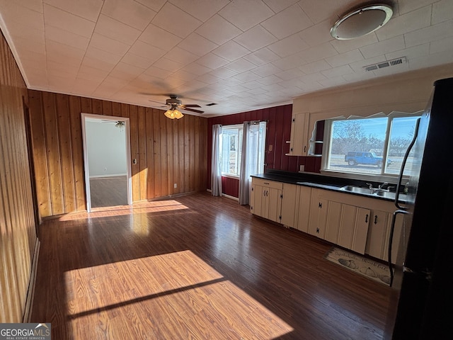 kitchen featuring black refrigerator, sink, dark hardwood / wood-style flooring, and plenty of natural light