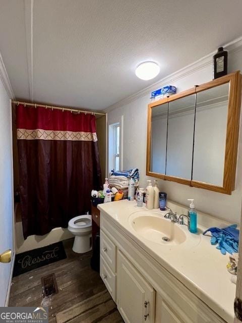 bathroom with toilet, a shower with curtain, wood-type flooring, ornamental molding, and vanity