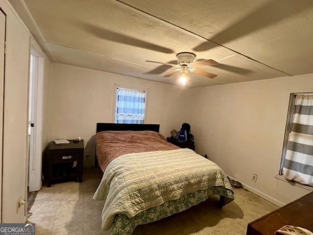 bedroom featuring a textured ceiling and ceiling fan