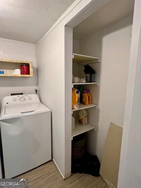 laundry room featuring washer / dryer and light hardwood / wood-style floors