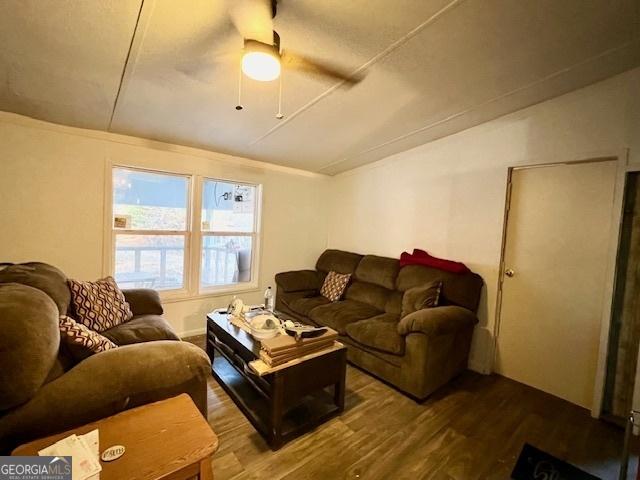 living room featuring wood-type flooring and ceiling fan