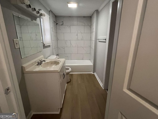 full bathroom with toilet, vanity, wood-type flooring, and tiled shower / bath combo