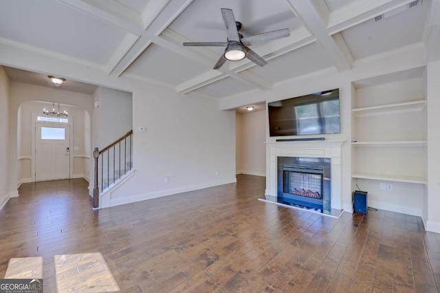 unfurnished living room featuring beam ceiling, ceiling fan, dark hardwood / wood-style flooring, and coffered ceiling