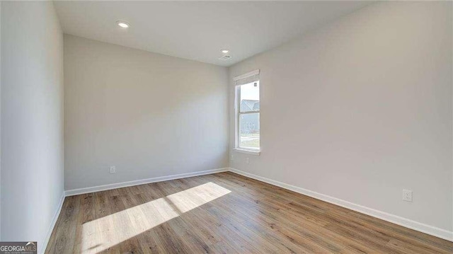 unfurnished room with light hardwood / wood-style flooring