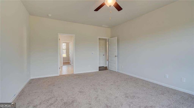 empty room with ceiling fan and light colored carpet