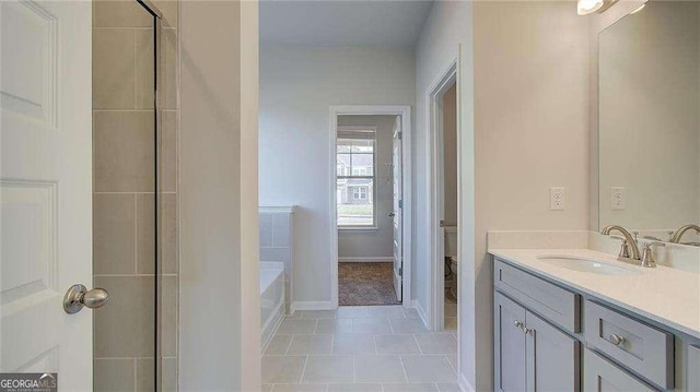 bathroom with a bathtub, tile patterned floors, toilet, and vanity