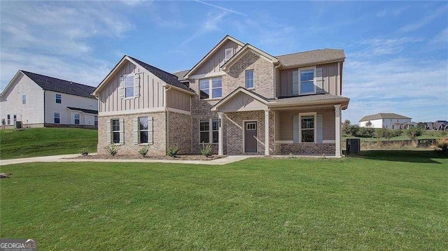 craftsman house featuring a front lawn and central AC