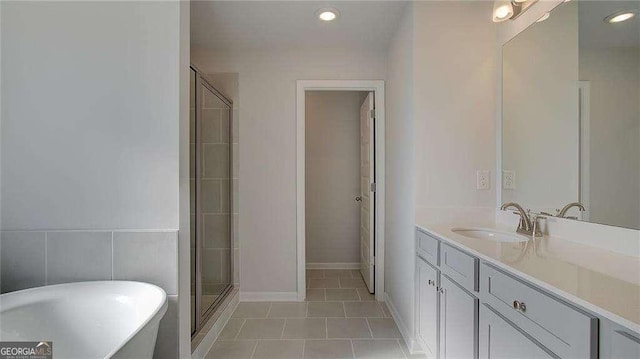 bathroom featuring shower with separate bathtub, vanity, and tile patterned flooring