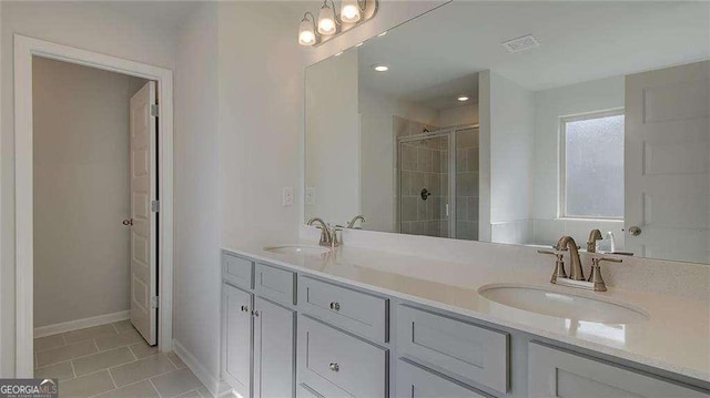 bathroom featuring walk in shower, tile patterned floors, and vanity