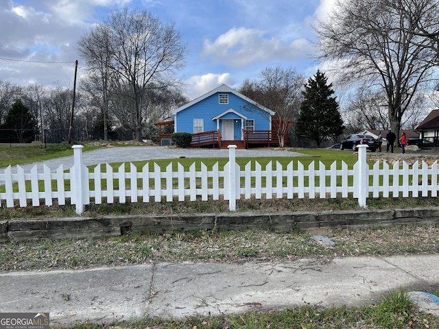 view of front of property with a front lawn and a deck