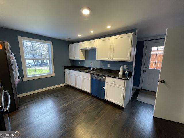 kitchen featuring dark wood-type flooring, sink, stainless steel appliances, and white cabinetry