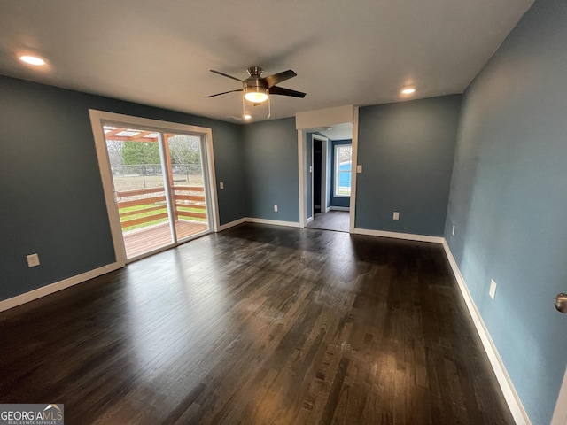 unfurnished room featuring ceiling fan, dark wood-type flooring, and a healthy amount of sunlight