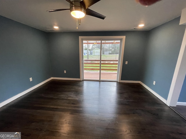 spare room featuring ceiling fan and dark hardwood / wood-style flooring