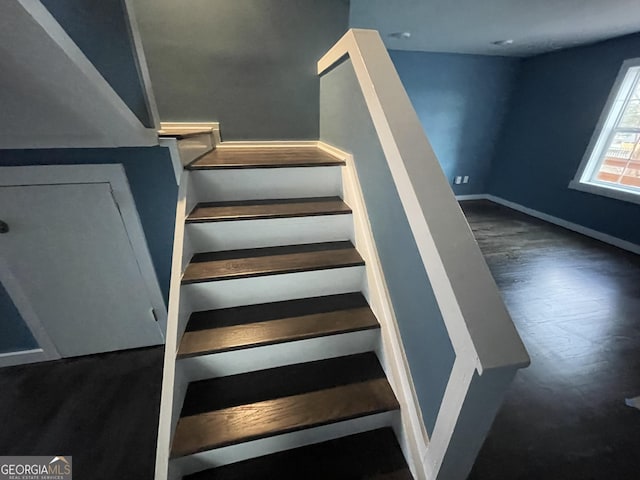 stairs with hardwood / wood-style flooring