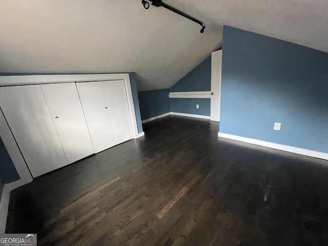 bonus room featuring dark hardwood / wood-style flooring and vaulted ceiling