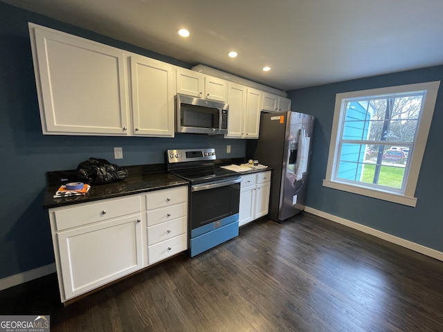 kitchen featuring stainless steel appliances, dark hardwood / wood-style flooring, and white cabinets