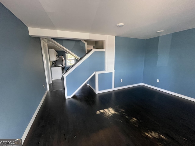 empty room with dark wood-type flooring