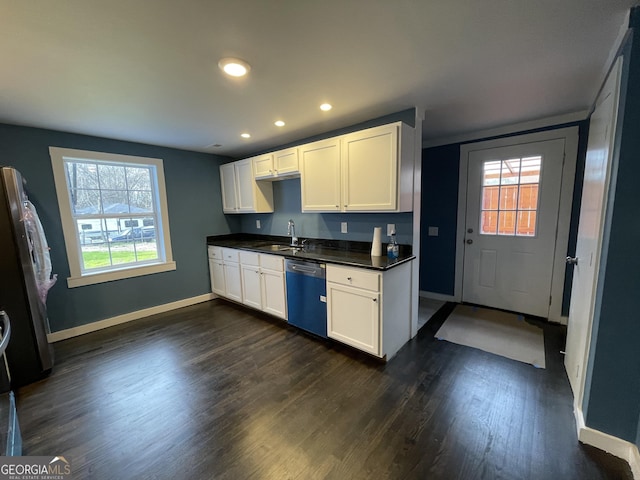 kitchen featuring dark wood-type flooring, stainless steel appliances, white cabinets, and sink