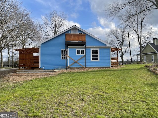 rear view of house with a lawn