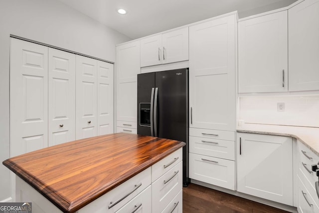 3047 Lenox Rd NE Unit 1108, Atlanta, GA 30324 - kitchen with dark hardwood / wood-style floors, white cabinetry, butcher block counters, and black fridge with ice dispenser