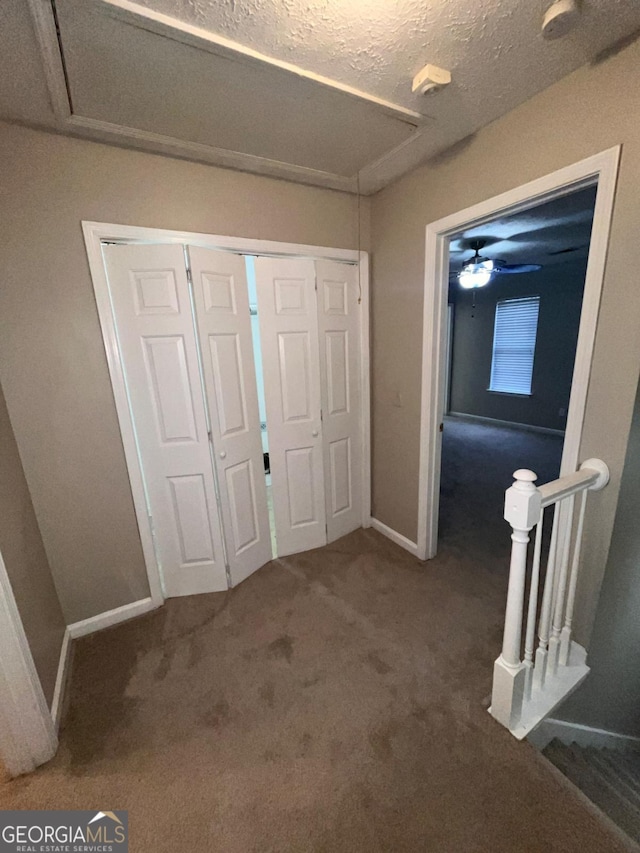 unfurnished bedroom with carpet floors and a textured ceiling