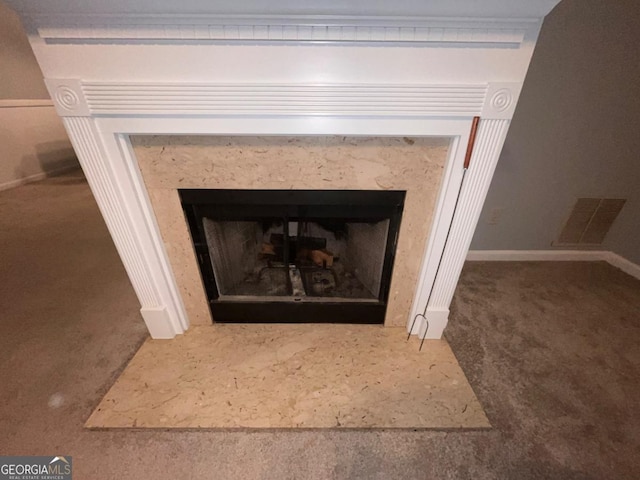 details featuring carpet floors and a premium fireplace