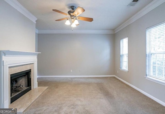 unfurnished living room with ornamental molding, light carpet, ceiling fan, and a high end fireplace