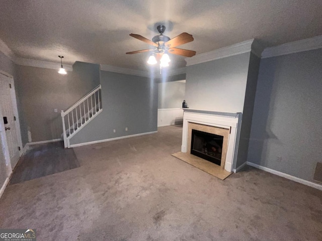 unfurnished living room with ceiling fan, ornamental molding, carpet floors, and a textured ceiling