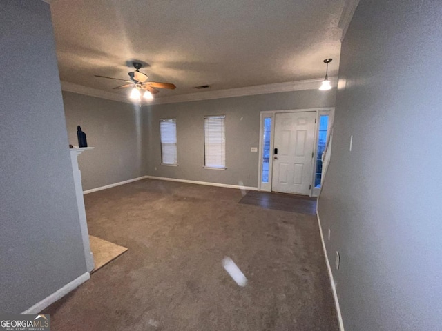 entrance foyer featuring crown molding, ceiling fan, carpet, and a textured ceiling