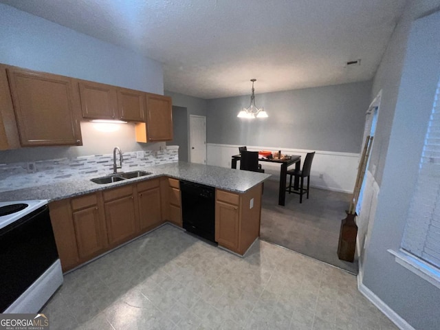 kitchen with sink, dishwasher, hanging light fixtures, kitchen peninsula, and a chandelier