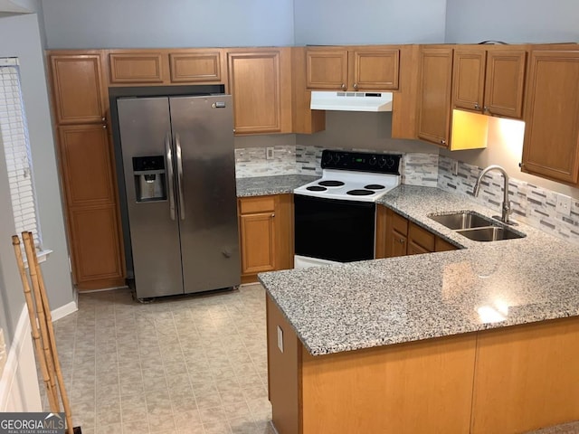 kitchen with sink, light stone counters, stainless steel fridge with ice dispenser, electric range oven, and kitchen peninsula