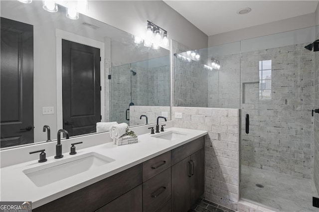 bathroom featuring walk in shower and vanity