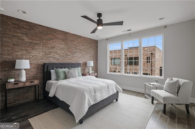 bedroom with ceiling fan and hardwood / wood-style flooring