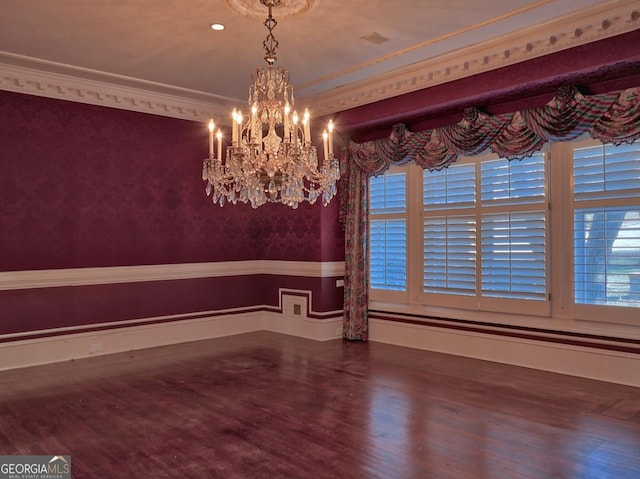 unfurnished dining area with a notable chandelier, ornamental molding, and hardwood / wood-style floors