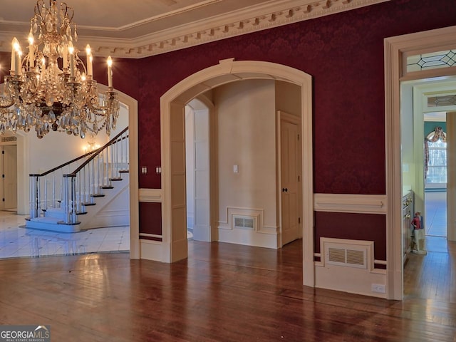 interior space with hardwood / wood-style flooring and crown molding