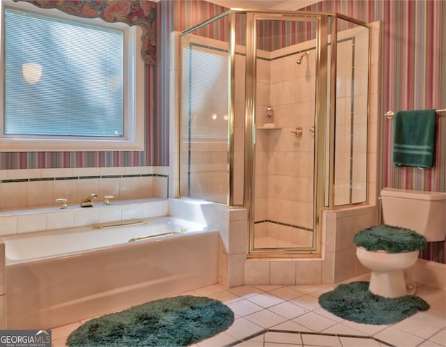 bathroom featuring toilet, tile patterned floors, and separate shower and tub