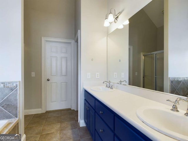 bathroom featuring tile patterned flooring, shower with separate bathtub, and vanity