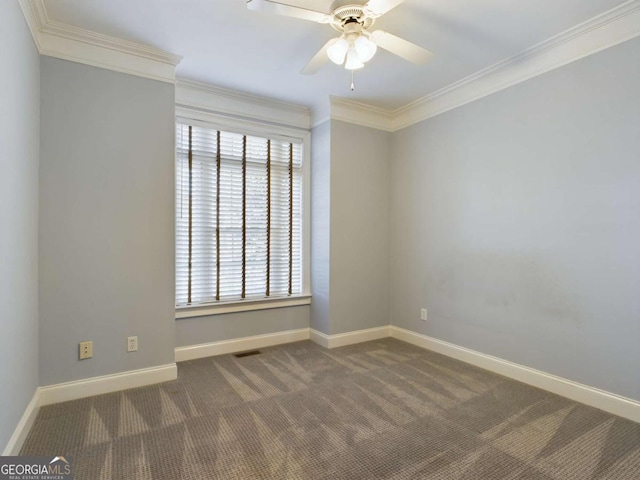 carpeted spare room featuring ceiling fan, ornamental molding, and plenty of natural light