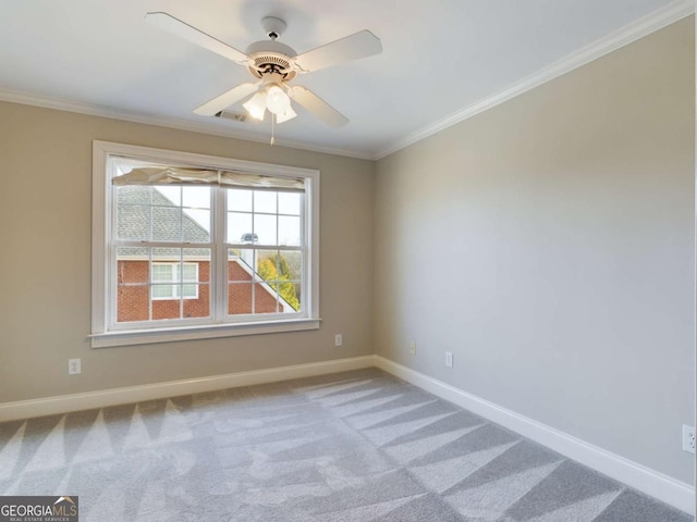 spare room with ceiling fan, ornamental molding, and carpet floors